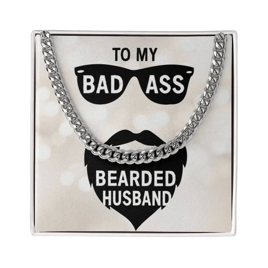 A silver chain handbag with a square silver frame, featuring a printed black graphic of sunglasses and a beard with the text 'TO MY BAD ASS BEARDED HUSBAND' on a light background.