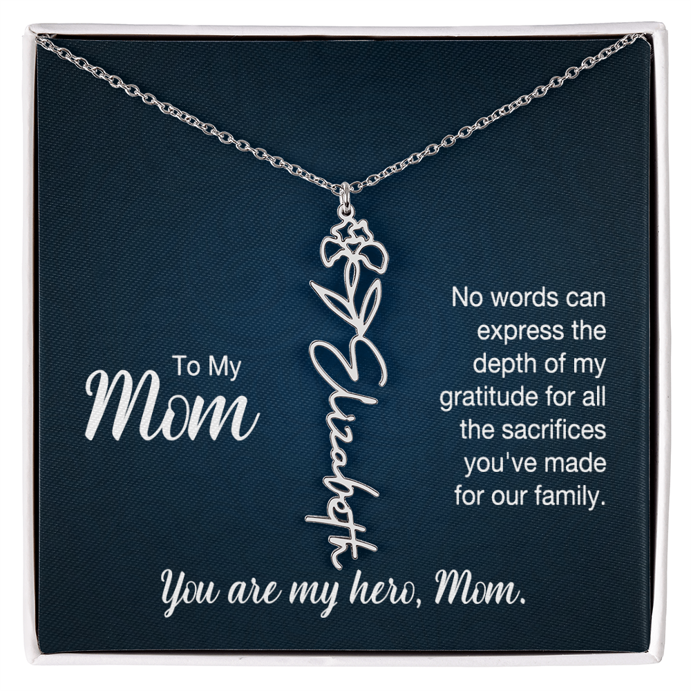 A silver floral filigree necklace with the name 'Elizabeth' engraved, presented on a dark blue gift card with sentimental text for 'Mom'.