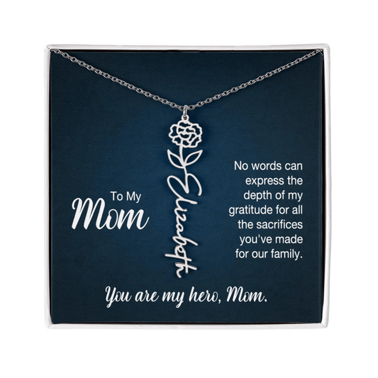 A silver floral filigree necklace with the name 'Elizabeth' engraved, presented on a dark blue gift card with sentimental text for 'Mom'.