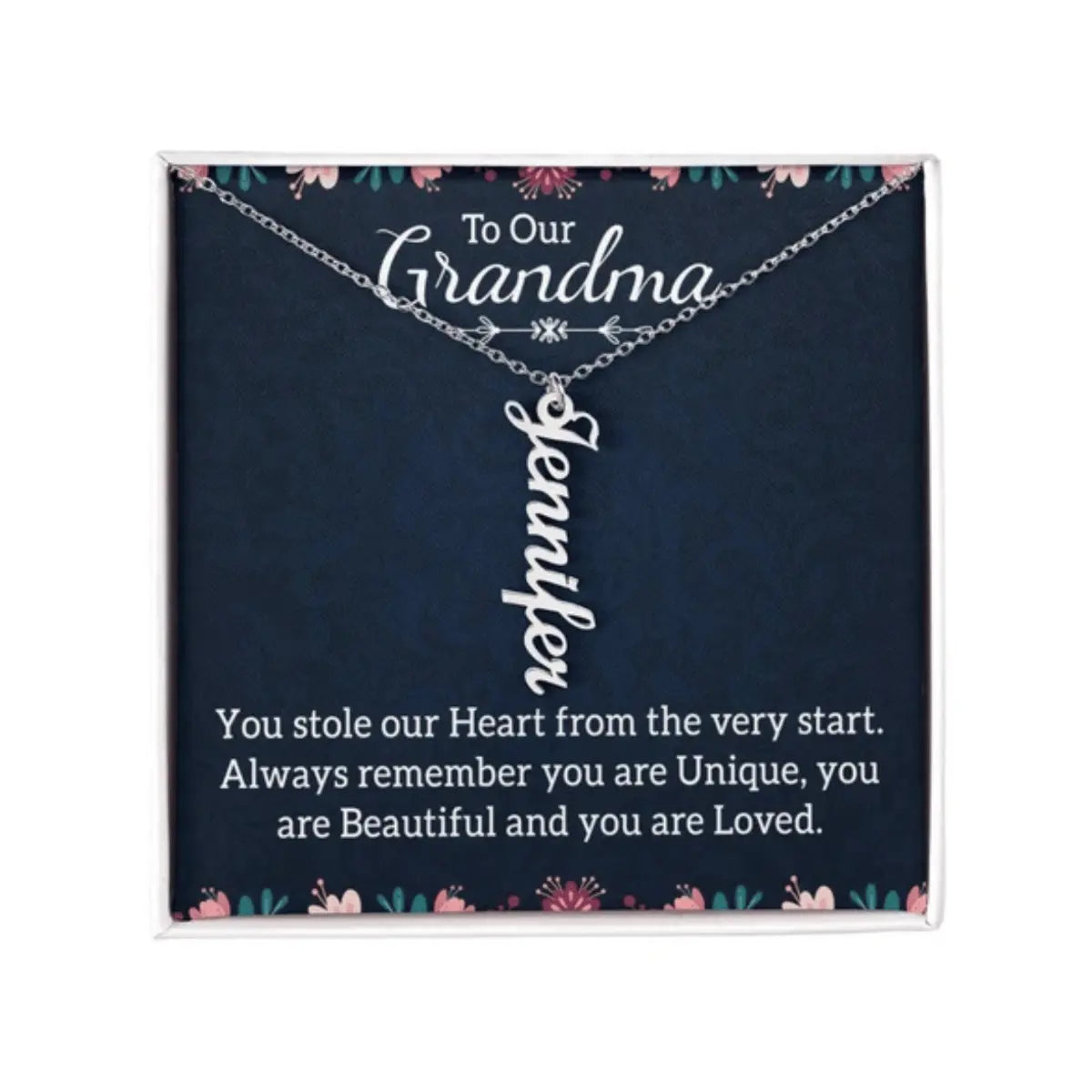 A personalized silver nameplate necklace displayed on a dark navy gift card with floral accents and a sentimental message for 'Grandma'.