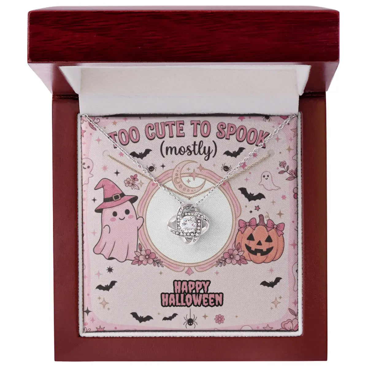 A silver-toned necklace with a circular cubic zirconia pendant displayed inside an open dark red gift box. The necklace is mounted on a pink Halloween-themed card with ghost, pumpkin, bat, and 'Happy Halloween' illustrations.