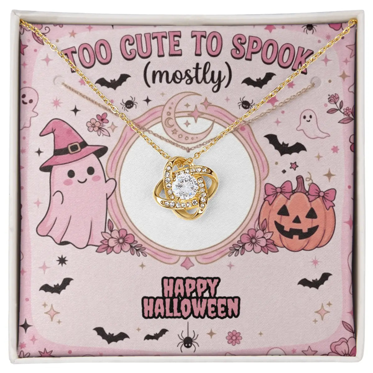 A gold-toned necklace with a swirling pendant cubic zirconia, presented on a pink Halloween-themed display card inside a gift box. The card features cute illustrations of a ghost in a witch hat, a jack-o'-lantern, bats, and the text 'TOO CUTE TO SPOOK (mostly)' and 'HAPPY HALLOWEEN'.