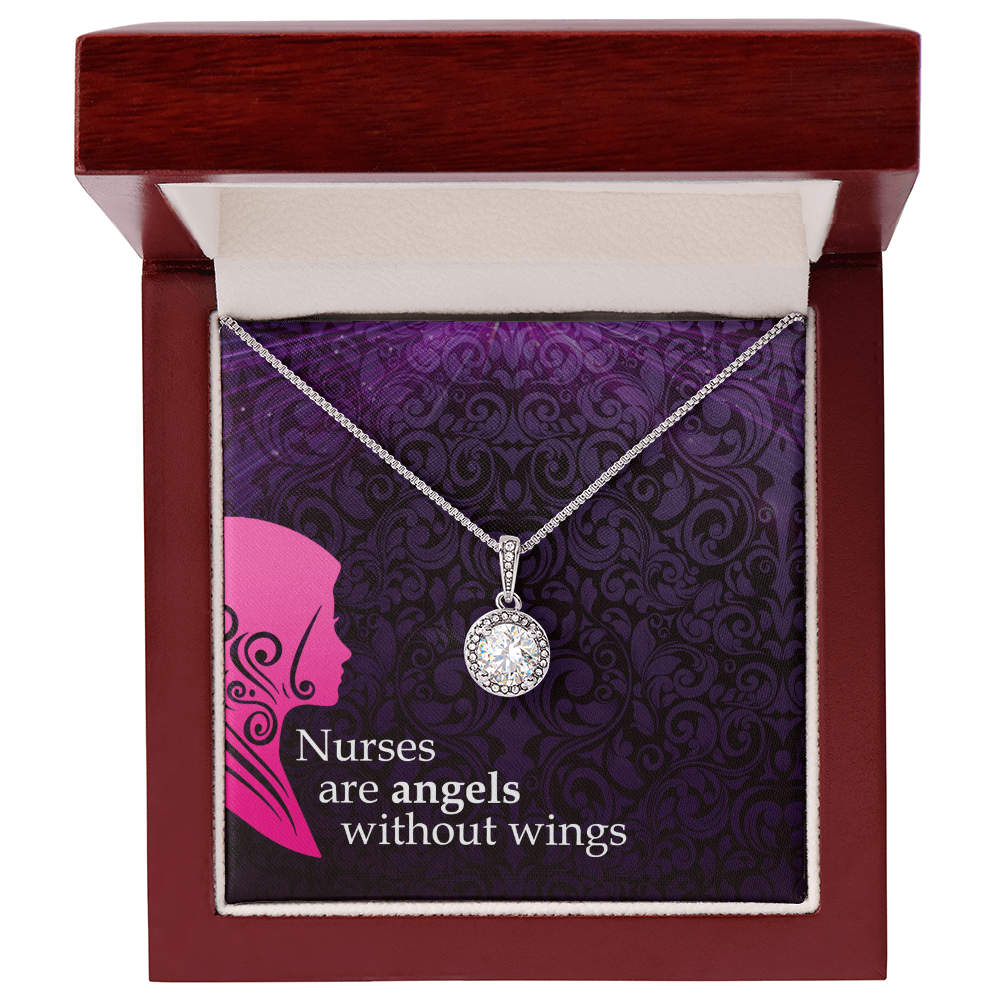 A silver chain necklace with a round, halo-set crystal pendant is presented inside an open wooden jewelry box with a dark border. The necklace rests against a decorative purple card with a damask pattern, a pink nurse silhouette, and the white text, "Nurses are angels without wings."