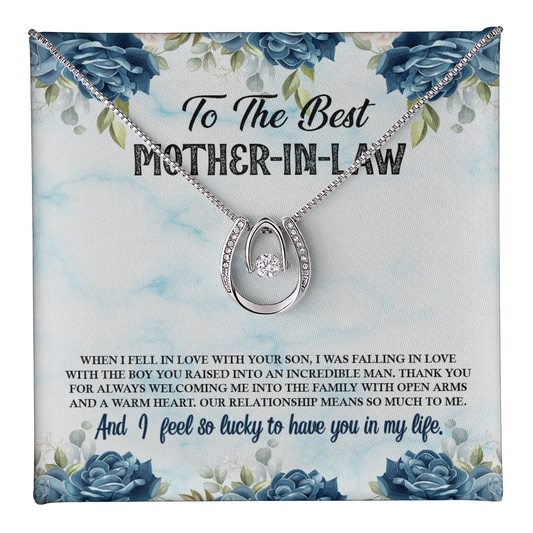 Silver horseshoe pendant necklace with a dancing cubic zirconia crystal center stone, displayed on a blue floral custom jewelry message card that reads "To The Best Mother-In-Law" from a daughter-in-law.