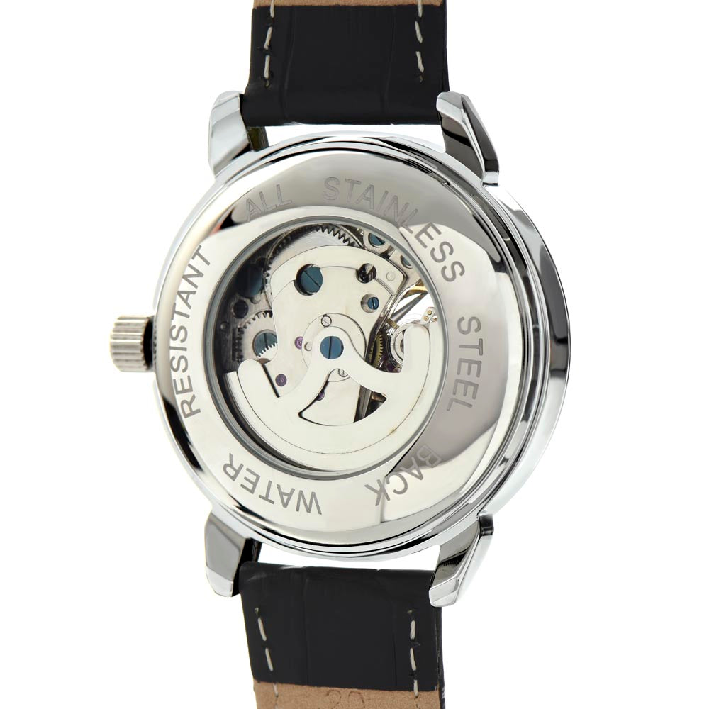 The silver stainless steel back of a men's skeleton watch showing that it is water resistant, and stainless steel.