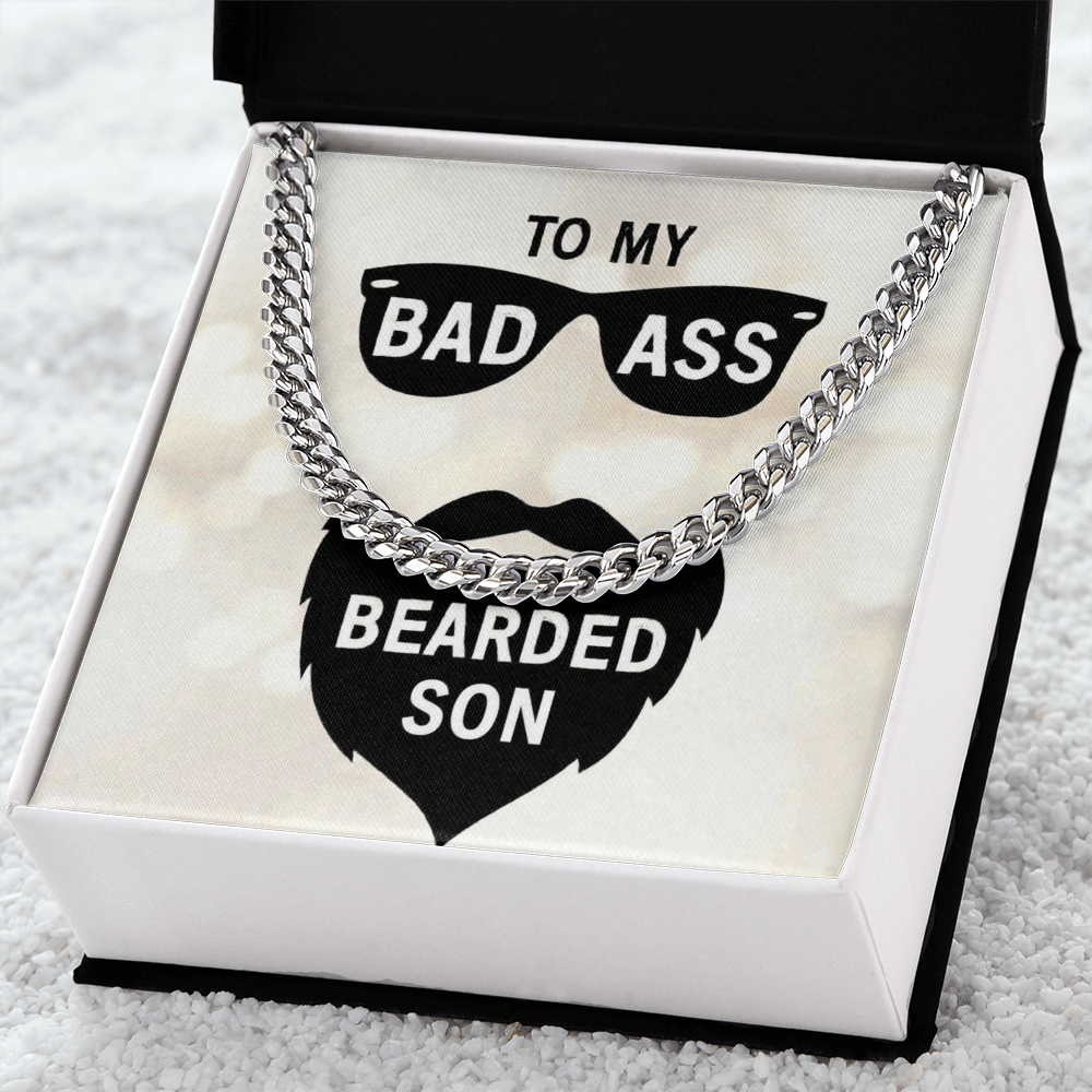 Polished stainless steel men's Cuban link chain necklace resting on a white gift box insert that reads "To My Bad Ass Bearded Cousin" with a sunglasses and beard graphic.