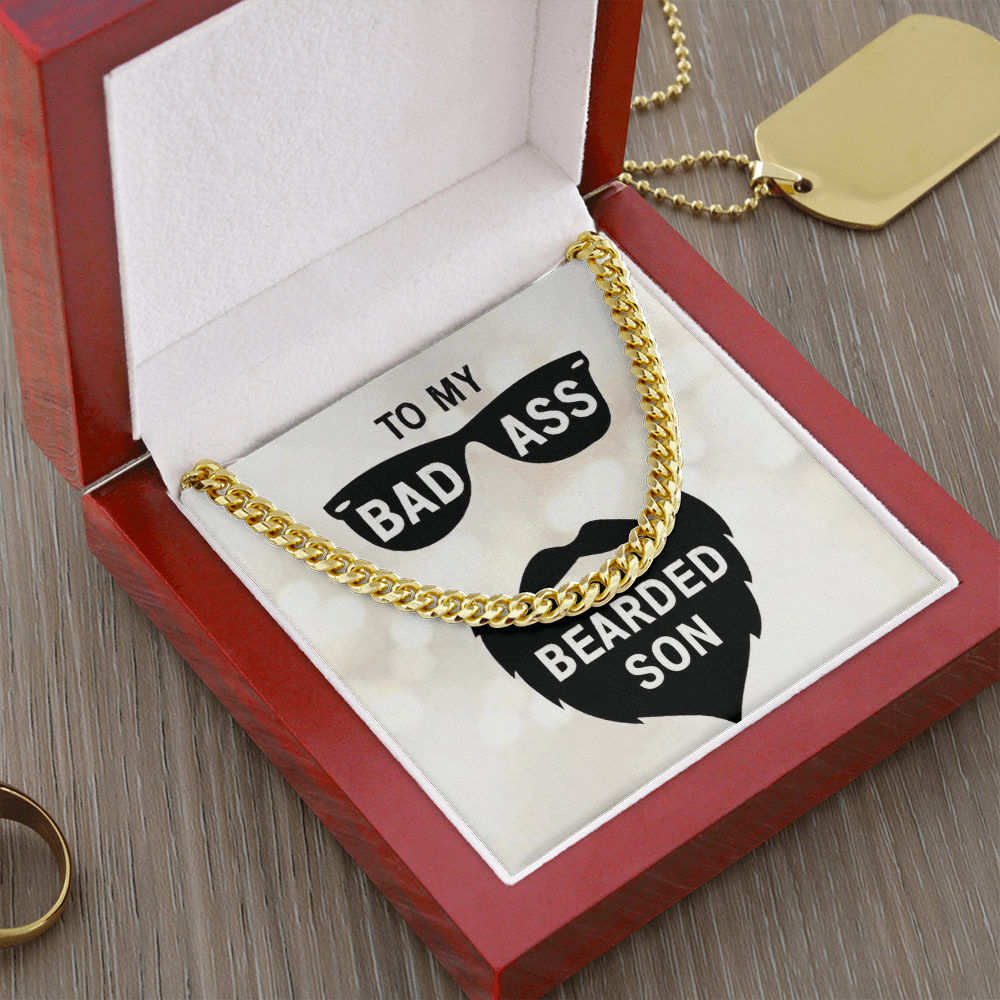 18k gold  men's Cuban link chain necklace resting in a wooden gift box insert that reads "To My Bad Ass Bearded Cousin" with a sunglasses and beard graphic.