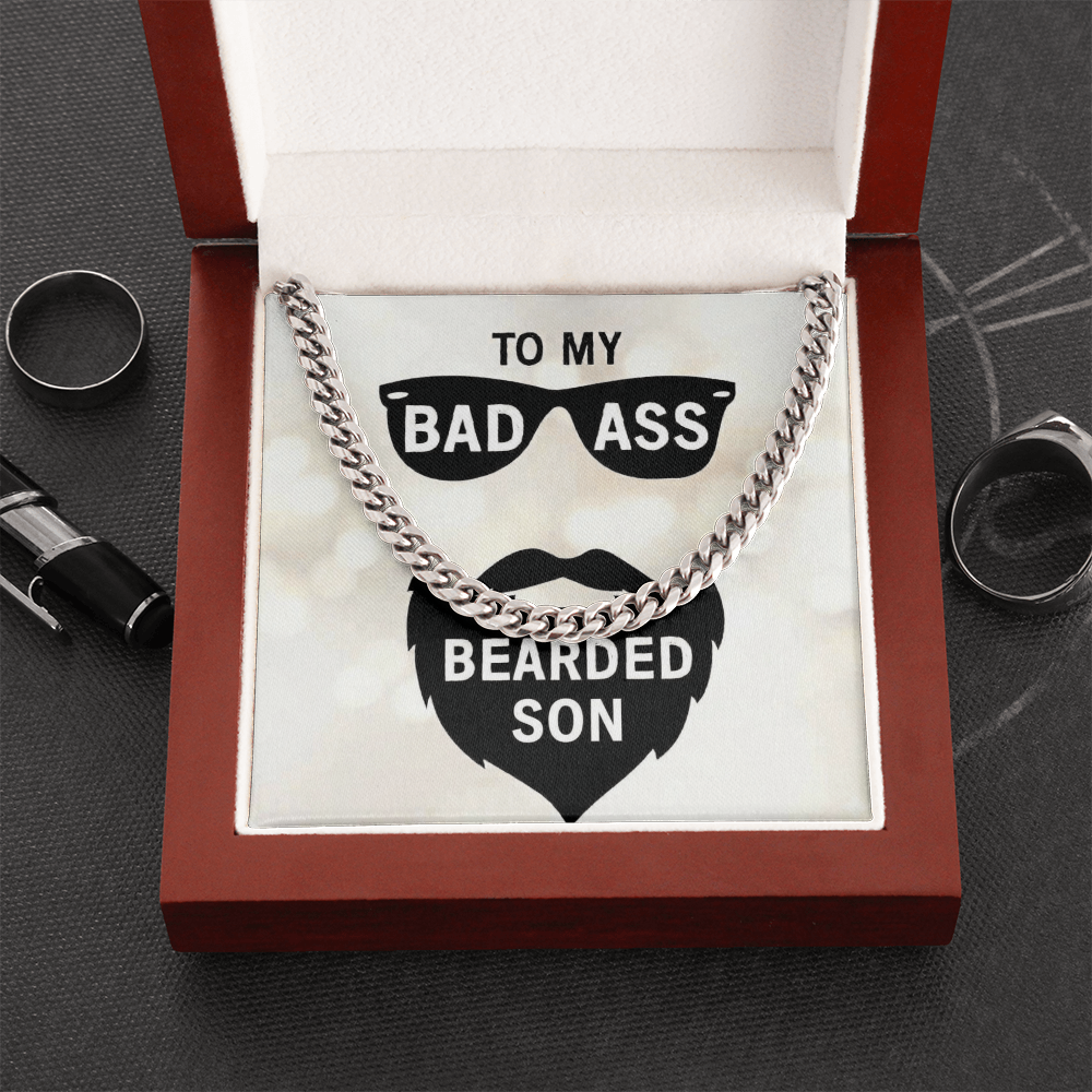 Polished stainless steel men's Cuban link chain necklace resting in a wooden gift box insert that reads "To My Bad Ass Bearded Cousin" with a sunglasses and beard graphic.