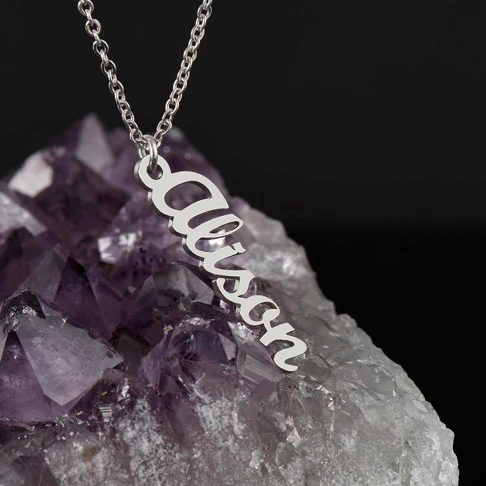 silver steel vertical name necklace on a purple amethyst crystal.