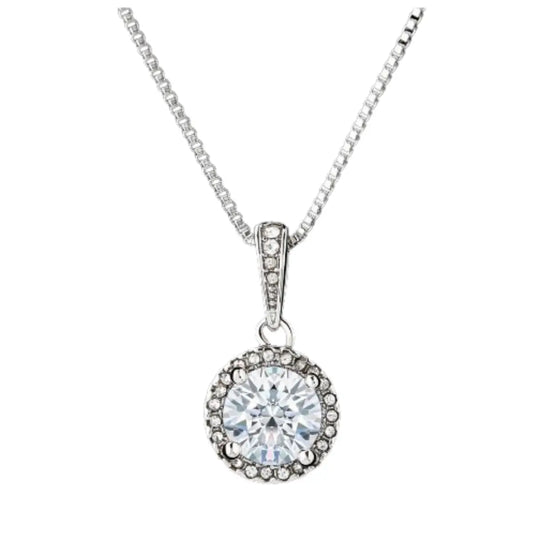 A silver round halo pendant necklace featuring a large, brilliant-cut central gemstone encircled by small pavé-set stones, hanging vertically from a classic box chain against a solid white background.