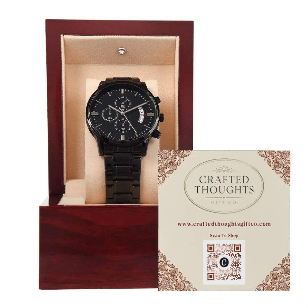 A black analog chronograph watch with a black metal link bracelet, displayed inside an open reddish-brown wooden gift box with a beige cushion. A branded card from Crafted Thoughts Gift Co.