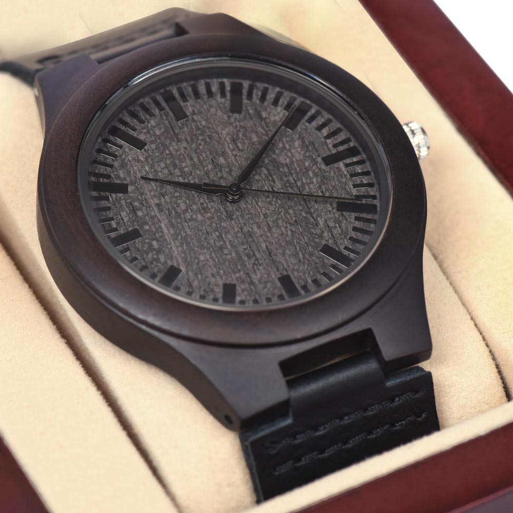 a brown wooden watch in a dark red led spotlight gift box with light cream color.