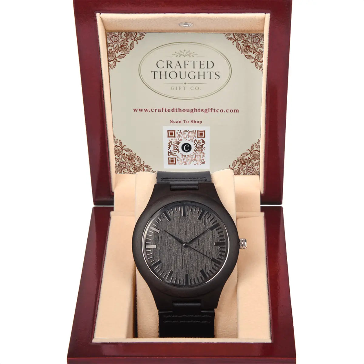 A brown wooden watch with a textured wood grain dial and matching black strap, presented inside an open dark red gift box with a beige interior. The inside lid features the brand name 'Crafted Thoughts Gift Co.