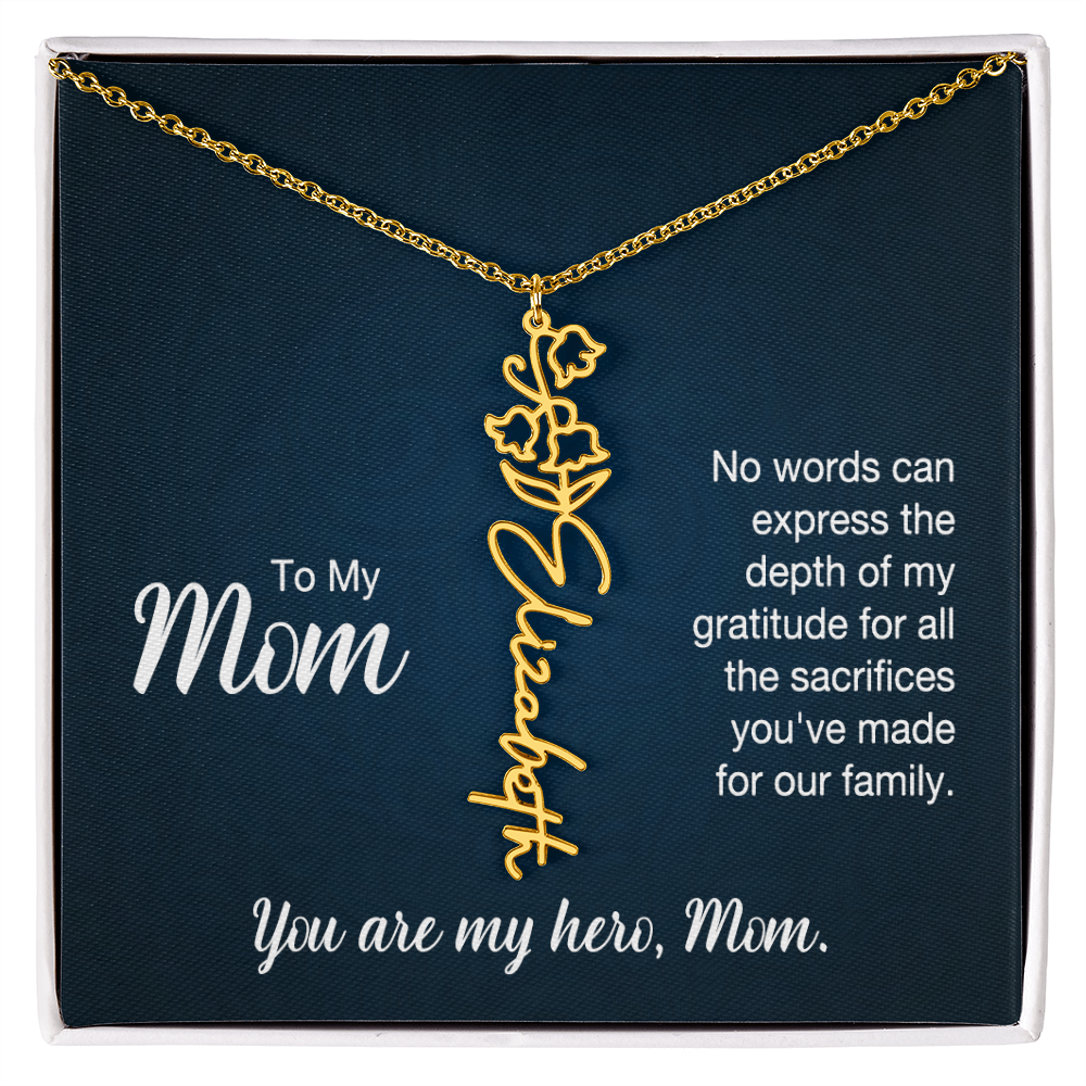 A gold floral filigree necklace with the name 'Elizabeth' engraved, presented on a dark blue gift card with sentimental text for 'Mom'.