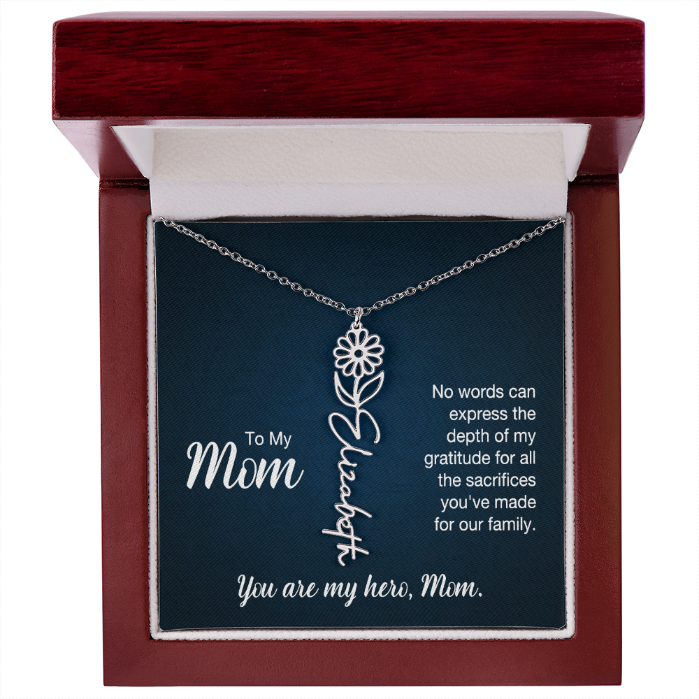 A silver floral filigree necklace with the name 'Elizabeth' engraved, presented on a dark blue gift card with sentimental text for 'Mom', in a luxury mahogany LED spotlight gift box.