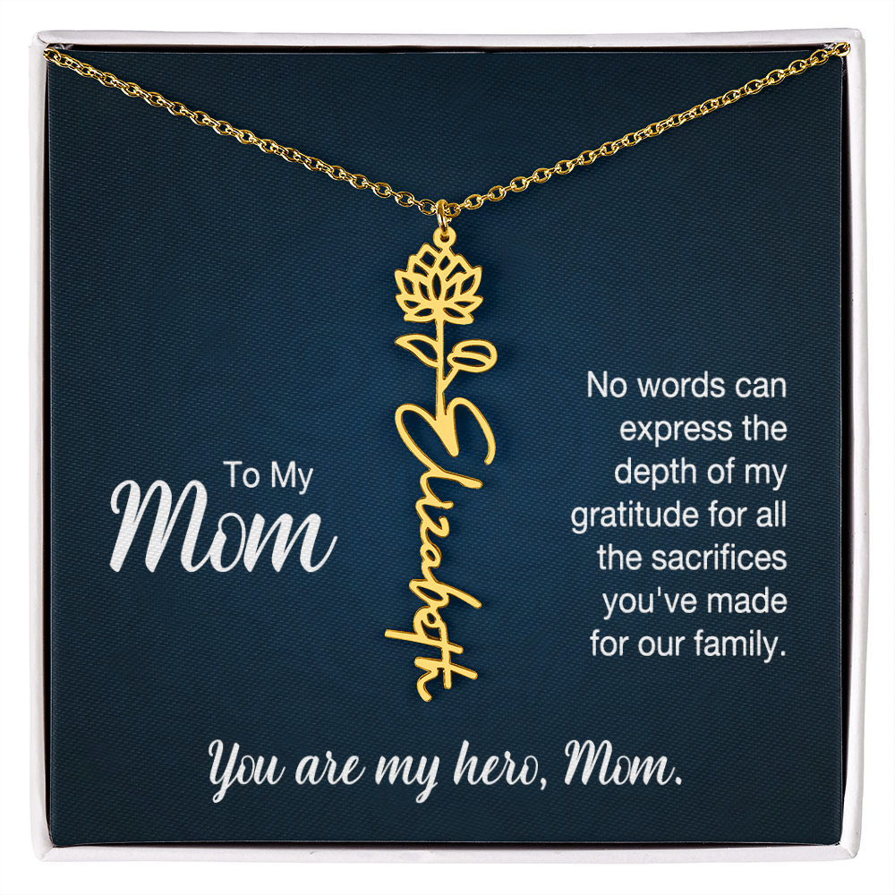 A gold floral filigree necklace with the name 'Elizabeth' engraved, presented on a dark blue gift card with sentimental text for 'Mom'.