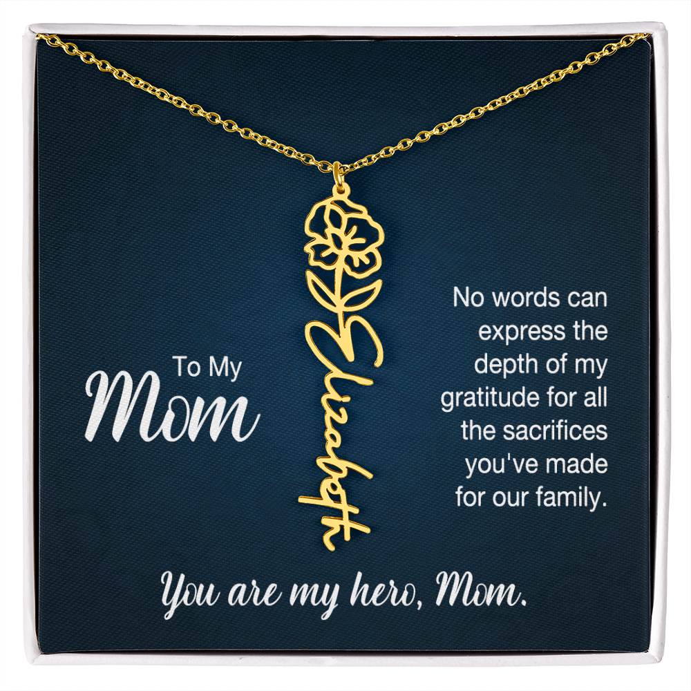 A gold floral filigree necklace with the name 'Elizabeth' engraved, presented on a dark blue gift card with sentimental text for 'Mom'.