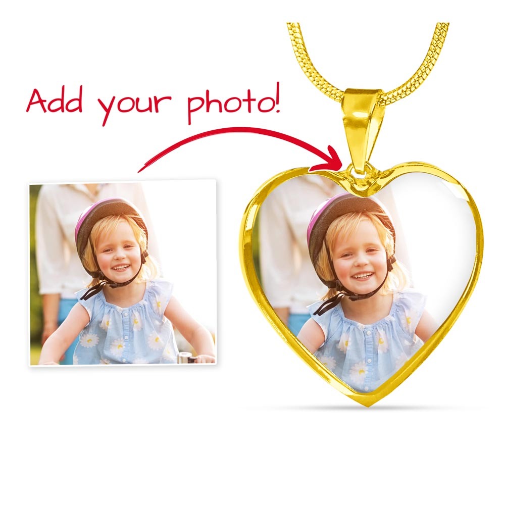 Custom heart photo necklace in gold with an engraved back, showing how a picture of a smiling child is embedded into the pendant as a personalized jewelry gift for a wife or mother.