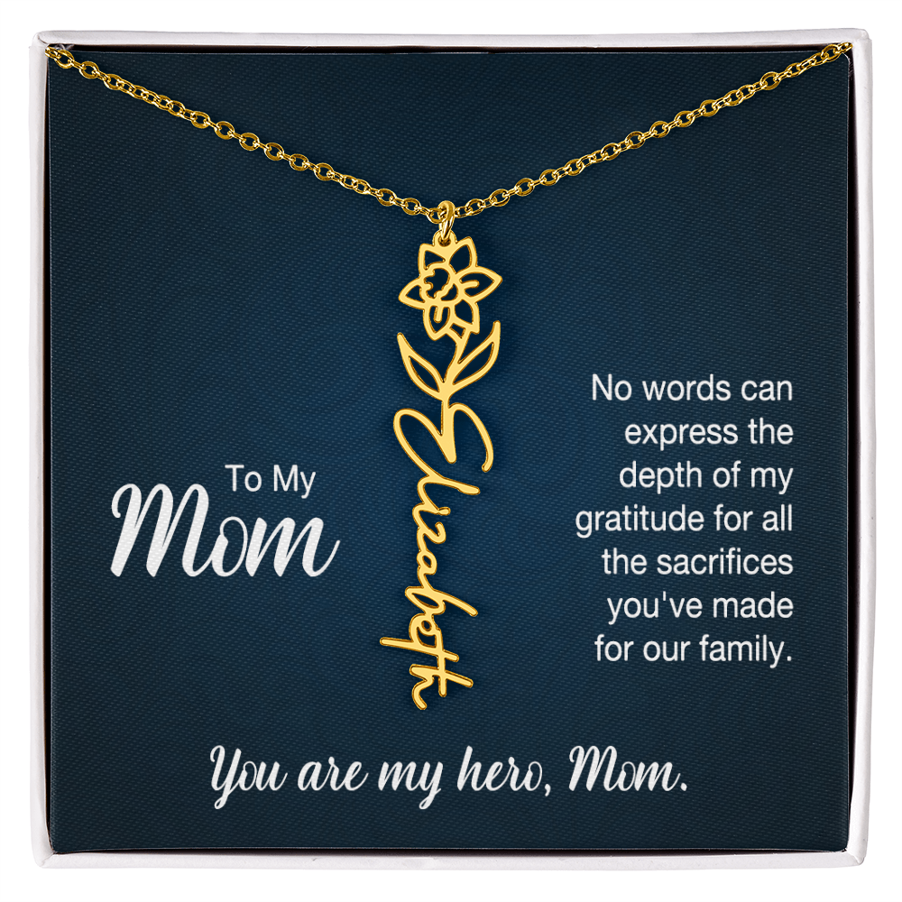 A gold floral filigree necklace with the name 'Elizabeth' engraved, presented on a dark blue gift card with sentimental text for 'Mom'.