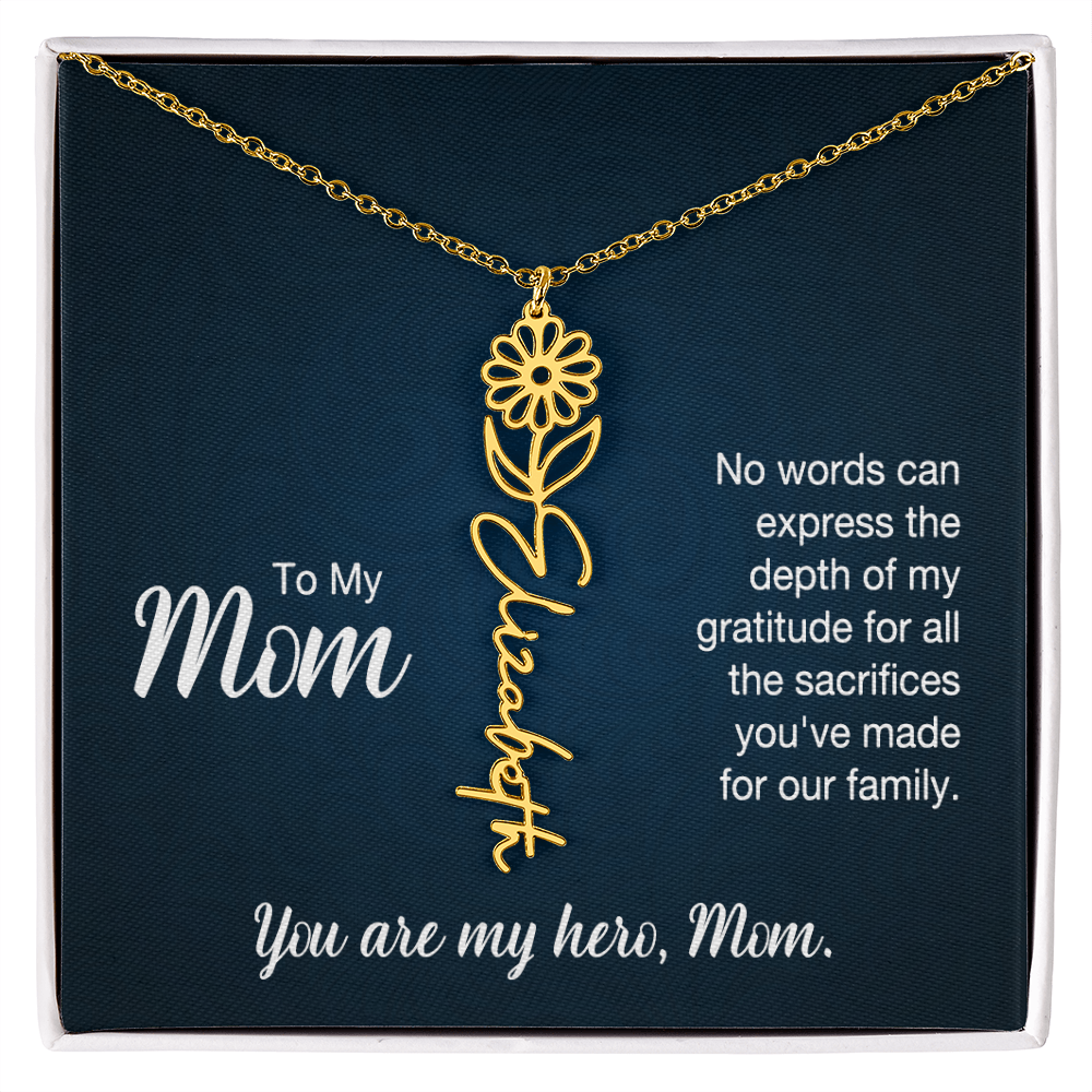 A gold floral filigree necklace with the name 'Elizabeth' engraved, presented on a dark blue gift card with sentimental text for 'Mom'.
