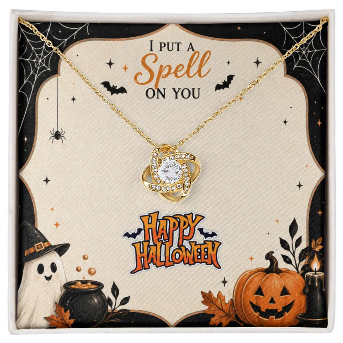 A gold necklace with a swirling atom pendant set with clear crystals, presented on a decorative Halloween-themed gift card that reads 'I PUT A Spell ON YOU' and 'Happy Halloween'.