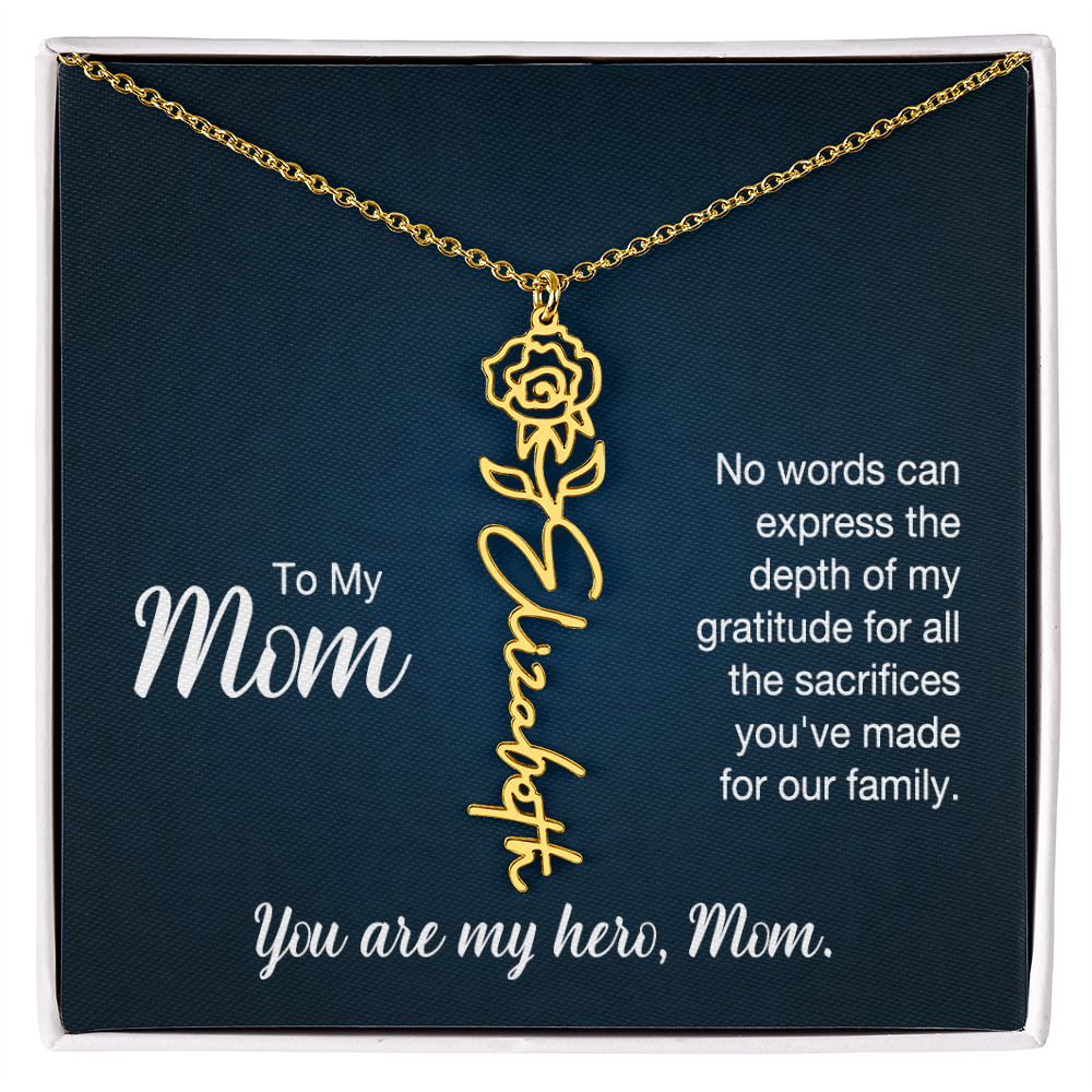 A gold floral filigree necklace with the name 'Elizabeth' engraved, presented on a dark blue gift card with sentimental text for 'Mom'.