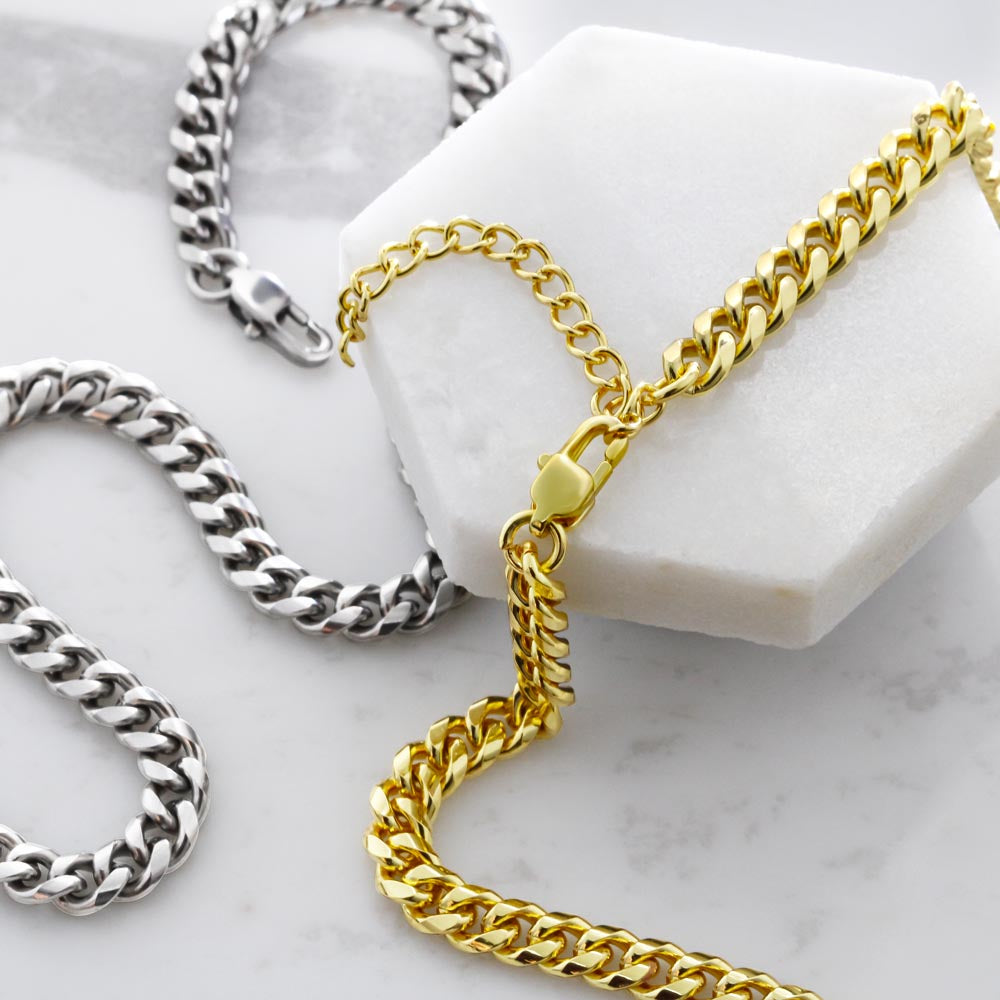 Gold and silver chain necklaces on a marble surface
