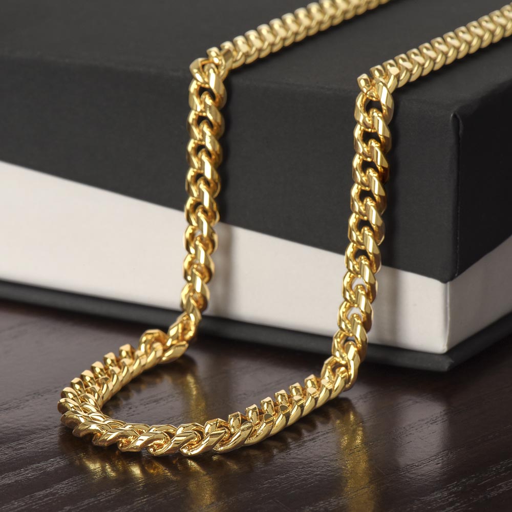 Gold chain on a black and white box
