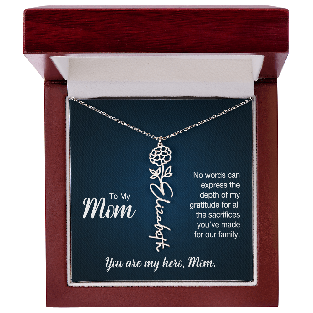 A silver floral filigree necklace with the name 'Elizabeth' engraved, presented on a dark blue gift card with sentimental text for 'Mom', in a luxury mahogany LED spotlight gift box.