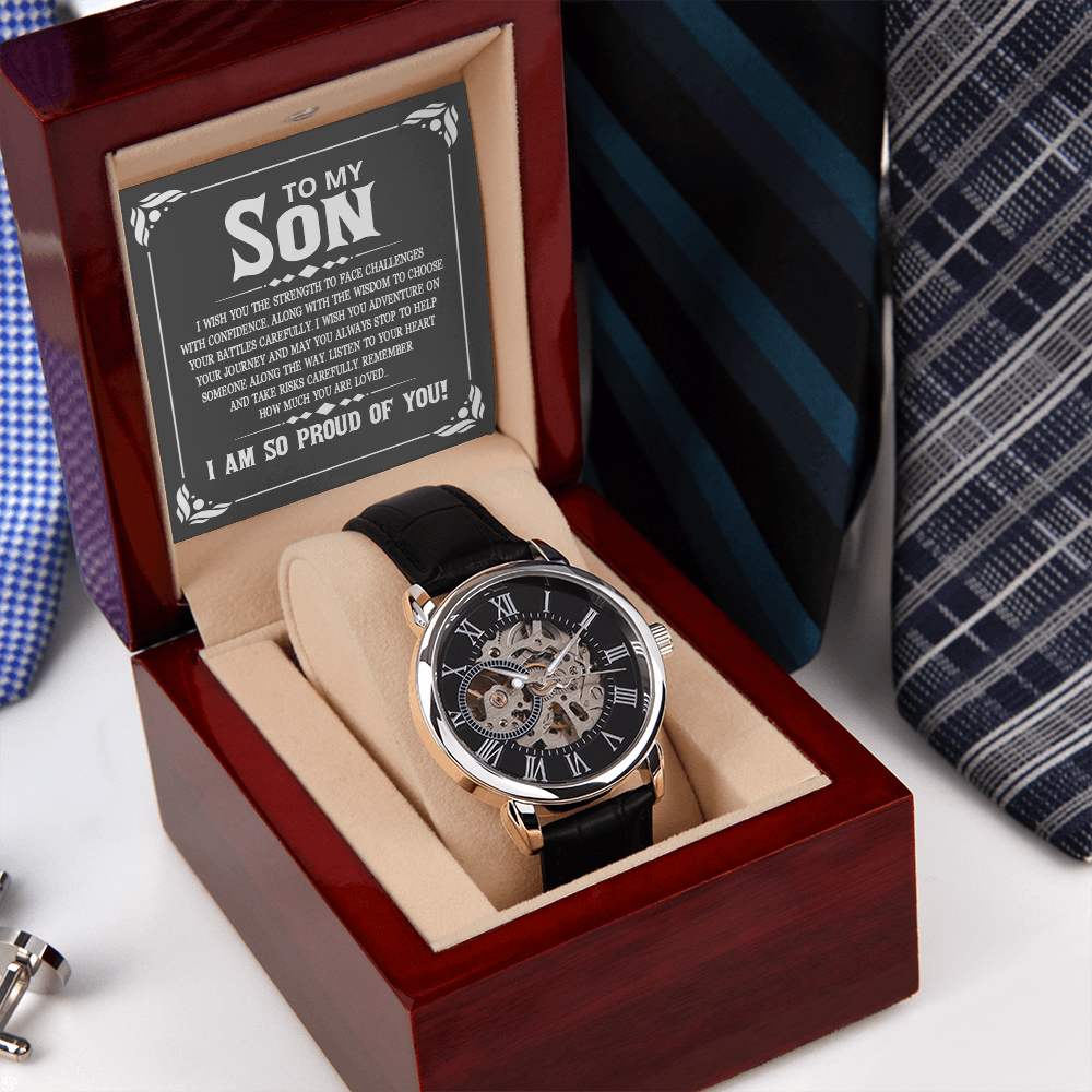 A close-up view of a men's openwork skeleton automatic watch with a black case back, resting inside an open luxury wooden gift box illuminated by an integrated LED light. The background features a neat, organized row of assorted men's ties displayed on a wooden surface.