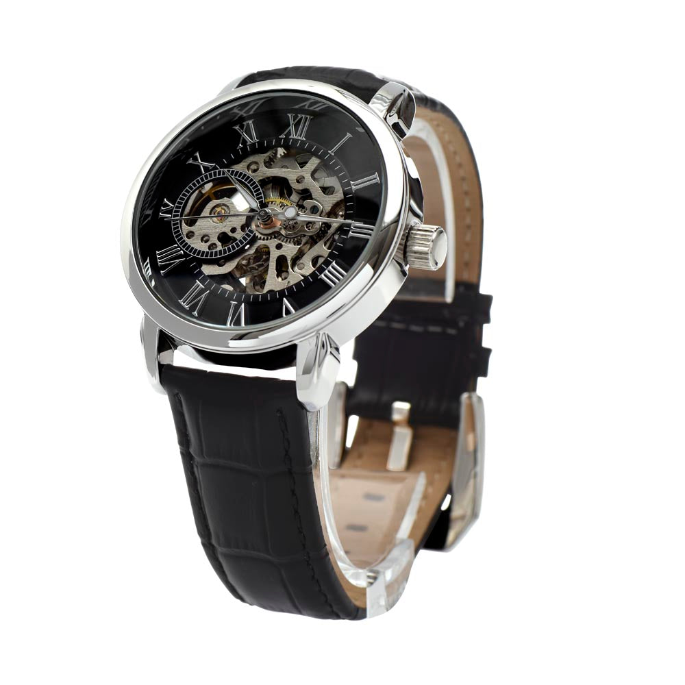 Close-up angled photograph of a men's openwork skeleton watch, showcasing the stainless steel case and genuine leather strap at a skewed perspective to highlight the dial, raised markers, and intricate internal mechanical layers.