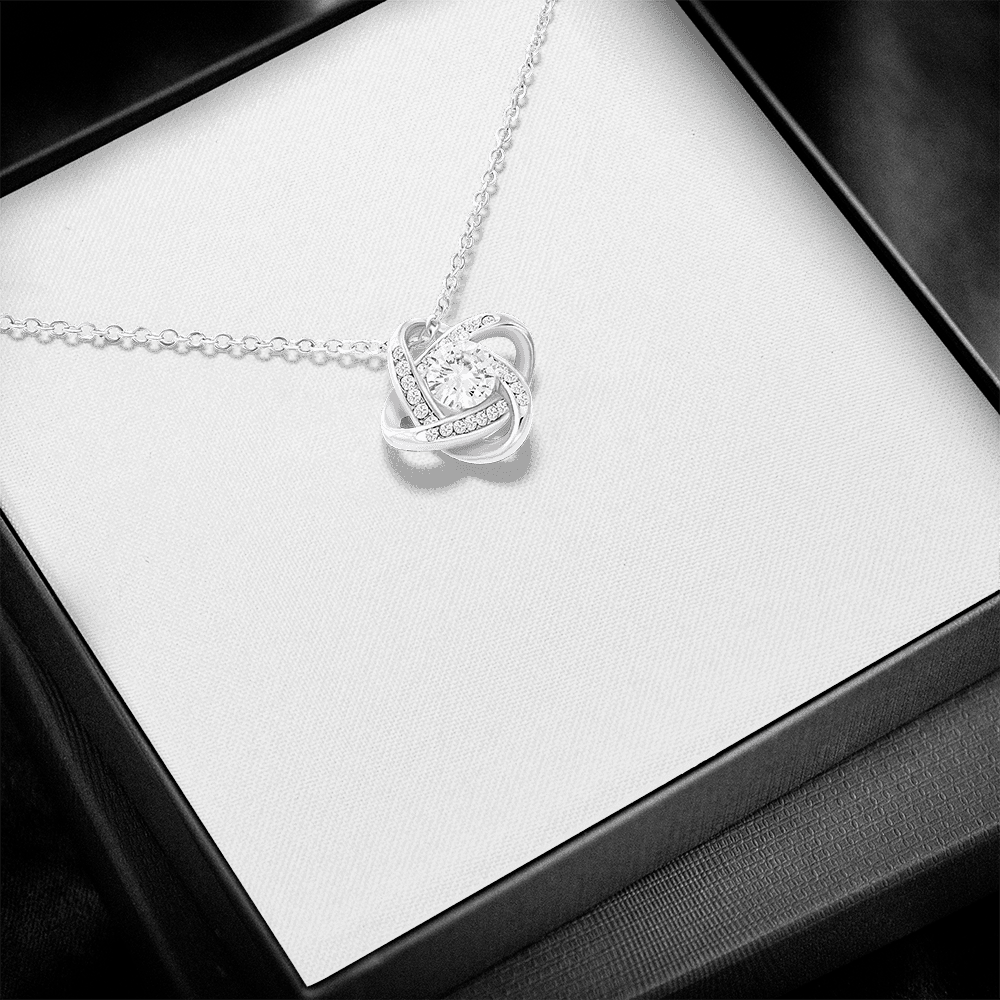 A personalized crown-up daughter necklace gift set in a black box, featuring a silver heart-shaped pendant on a chain and a printed message card with pink and black text and line art.