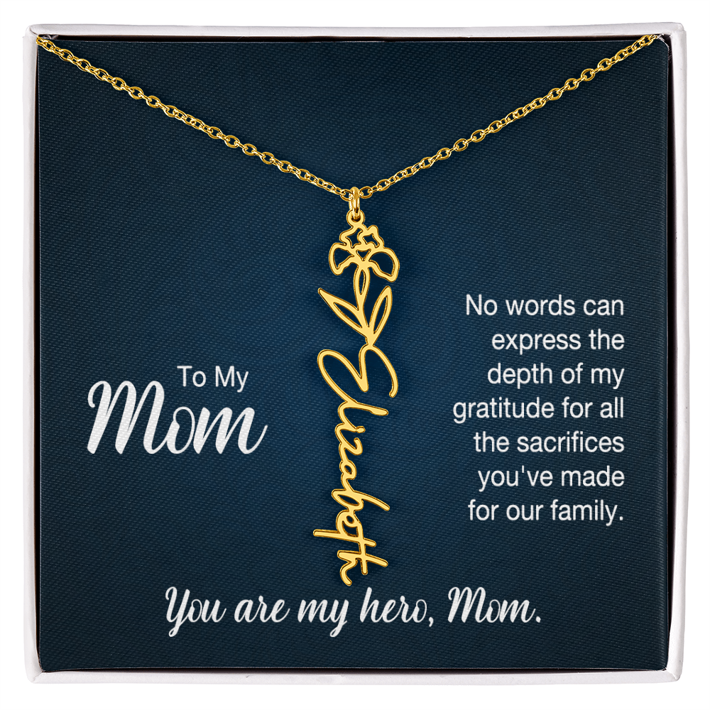 A gold floral filigree necklace with the name 'Elizabeth' engraved, presented on a dark blue gift card with sentimental text for 'Mom'.