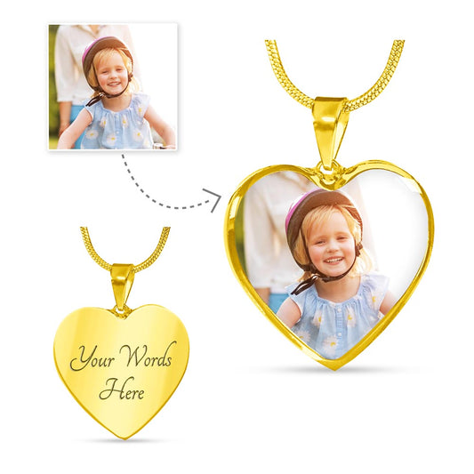 Personalized heart photo necklace in silver with an engraved back, showing how a picture of a smiling child is embedded into the pendant as a personalized jewelry gift for a wife or mother.