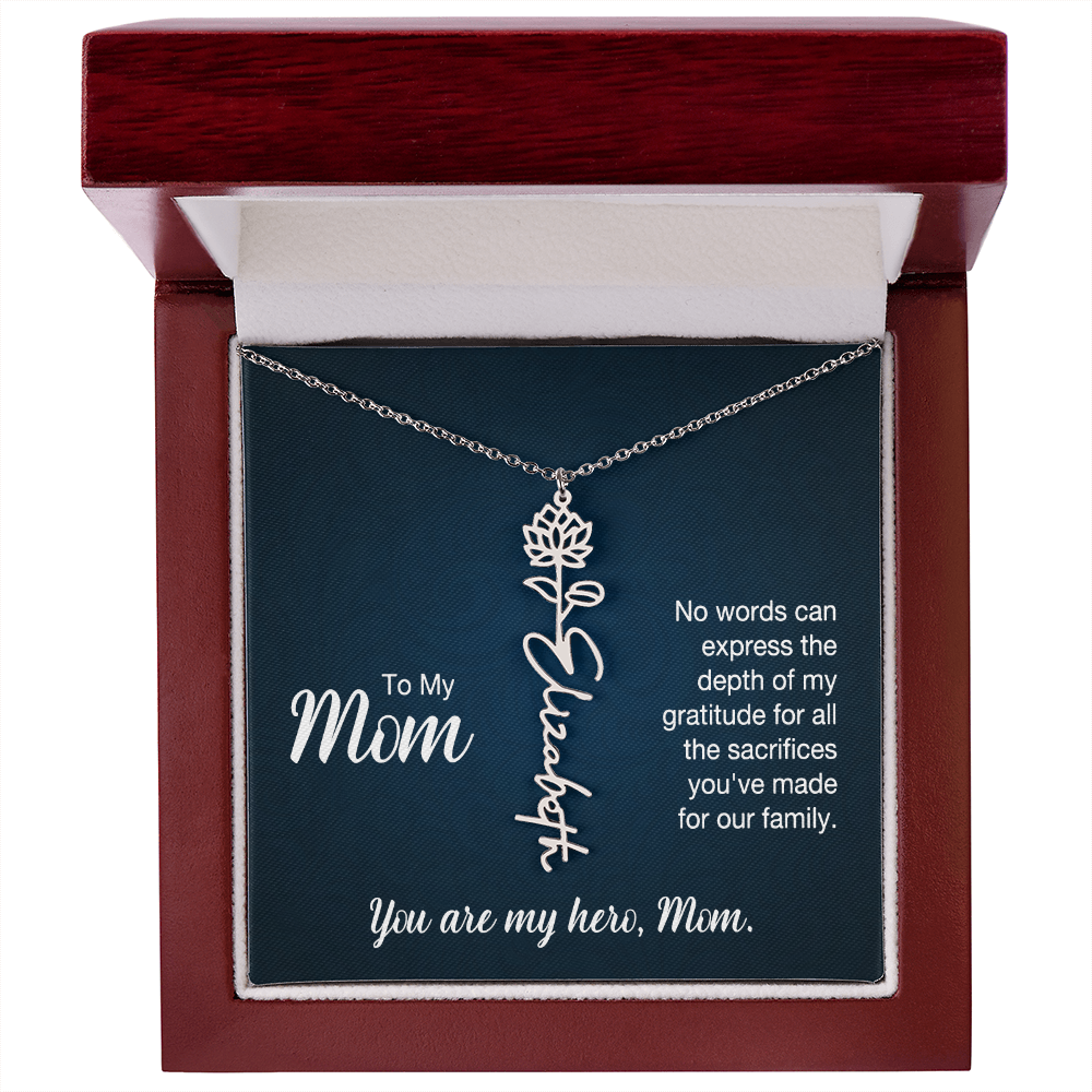 A silver floral filigree necklace with the name 'Elizabeth' engraved, presented on a dark blue gift card with sentimental text for 'Mom', in a luxury mahogany LED spotlight gift box.