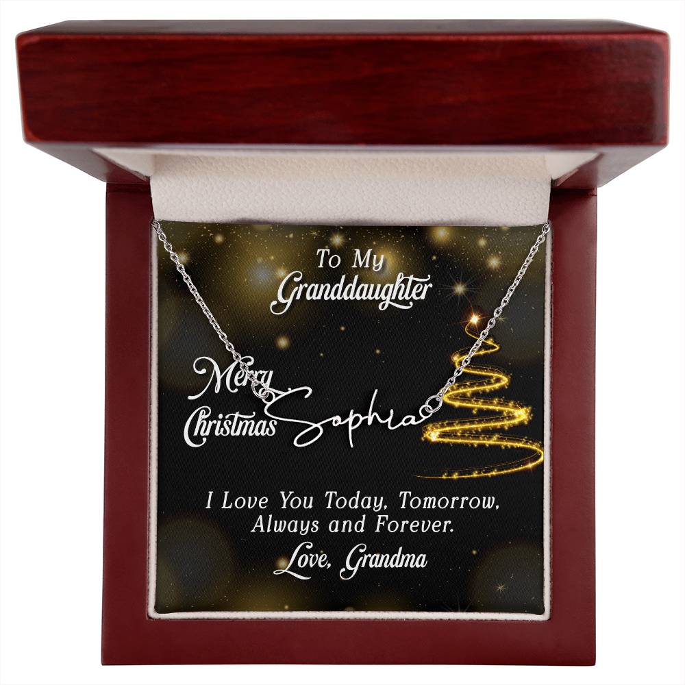 Silver personalized signature style name pendant necklace inside a dark wood gift box with a glitter Christmas tree jewelry card.