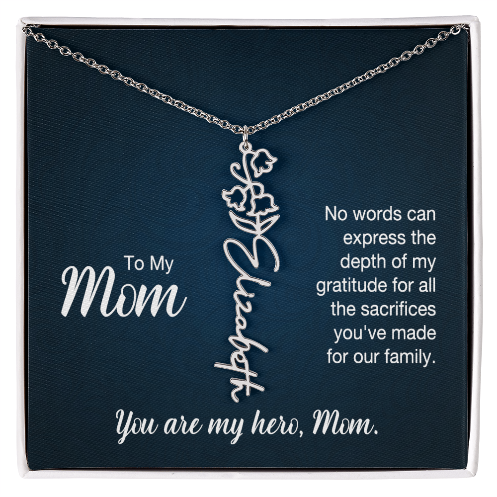 A silver floral filigree necklace with the name 'Elizabeth' engraved, presented on a dark blue gift card with sentimental text for 'Mom'.