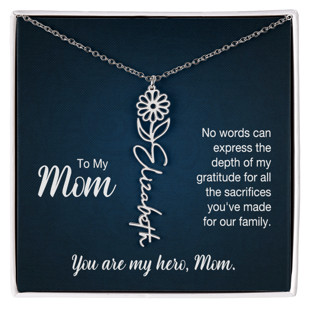 A silver floral filigree necklace with the name 'Elizabeth' engraved, presented on a dark blue gift card with sentimental text for 'Mom'.