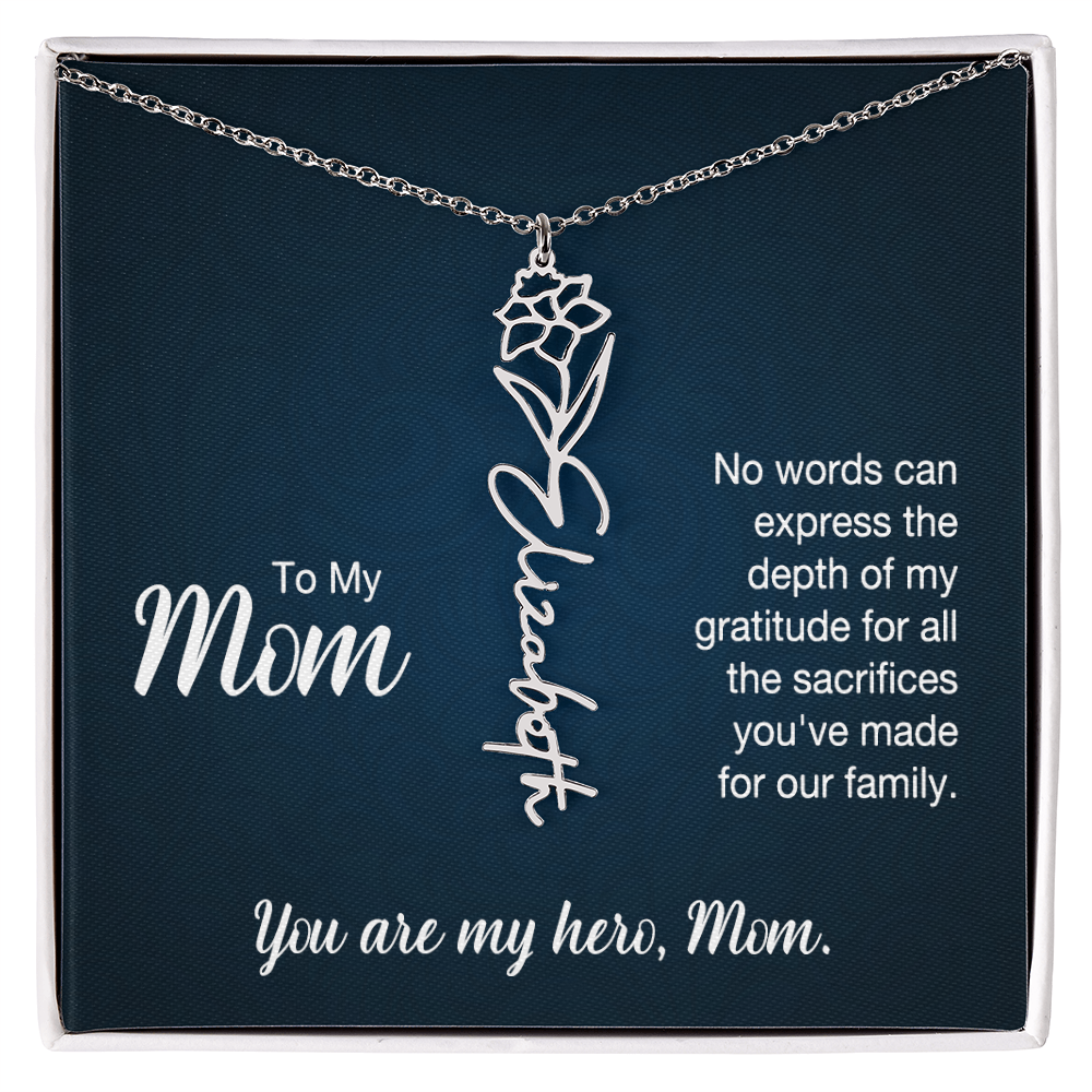 A silver floral filigree necklace with the name 'Elizabeth' engraved, presented on a dark blue gift card with sentimental text for 'Mom'.