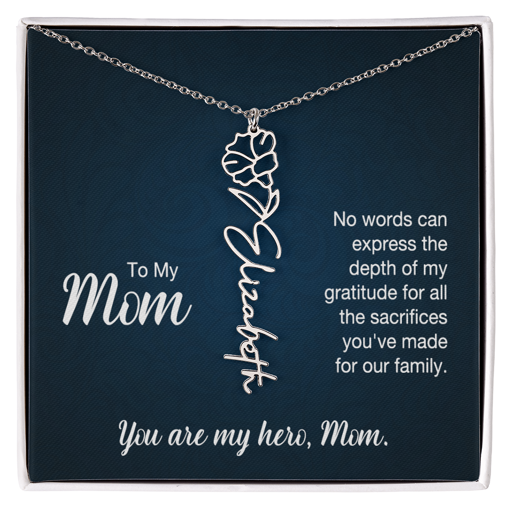 A silver floral filigree necklace with the name 'Elizabeth' engraved, presented on a dark blue gift card with sentimental text for 'Mom'.