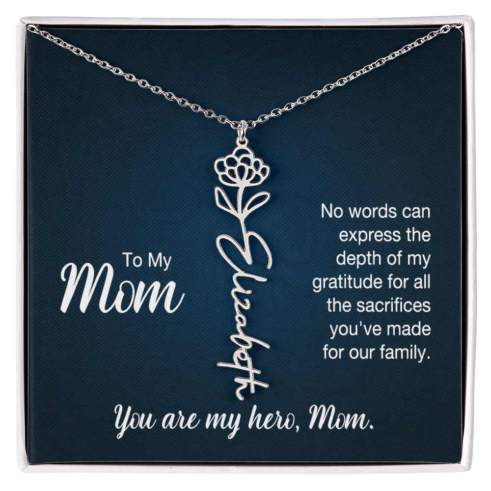 A silver floral filigree necklace with the name 'Elizabeth' engraved, presented on a dark blue gift card with sentimental text for 'Mom'.