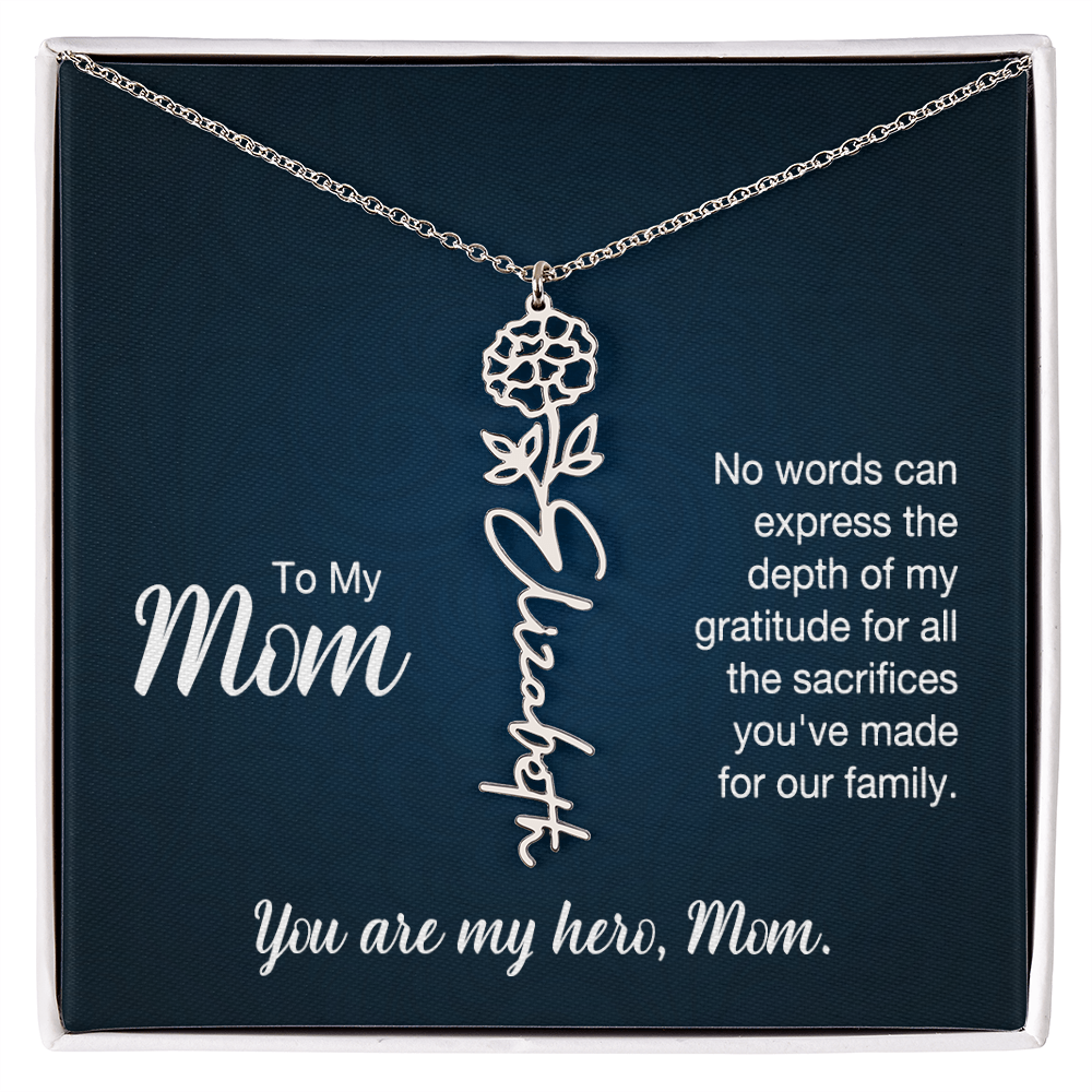 A silver floral filigree necklace with the name 'Elizabeth' engraved, presented on a dark blue gift card with sentimental text for 'Mom'.