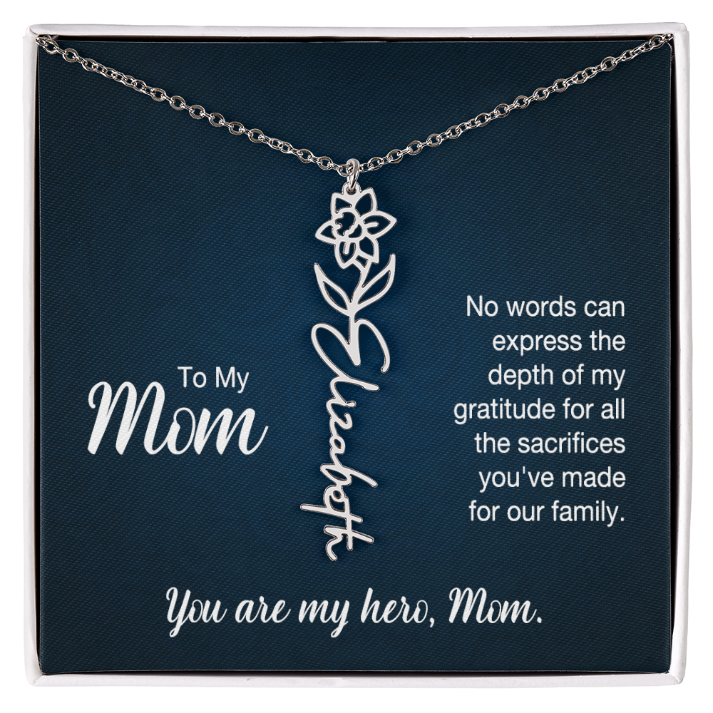 A silver floral filigree necklace with the name 'Elizabeth' engraved, presented on a dark blue gift card with sentimental text for 'Mom'.