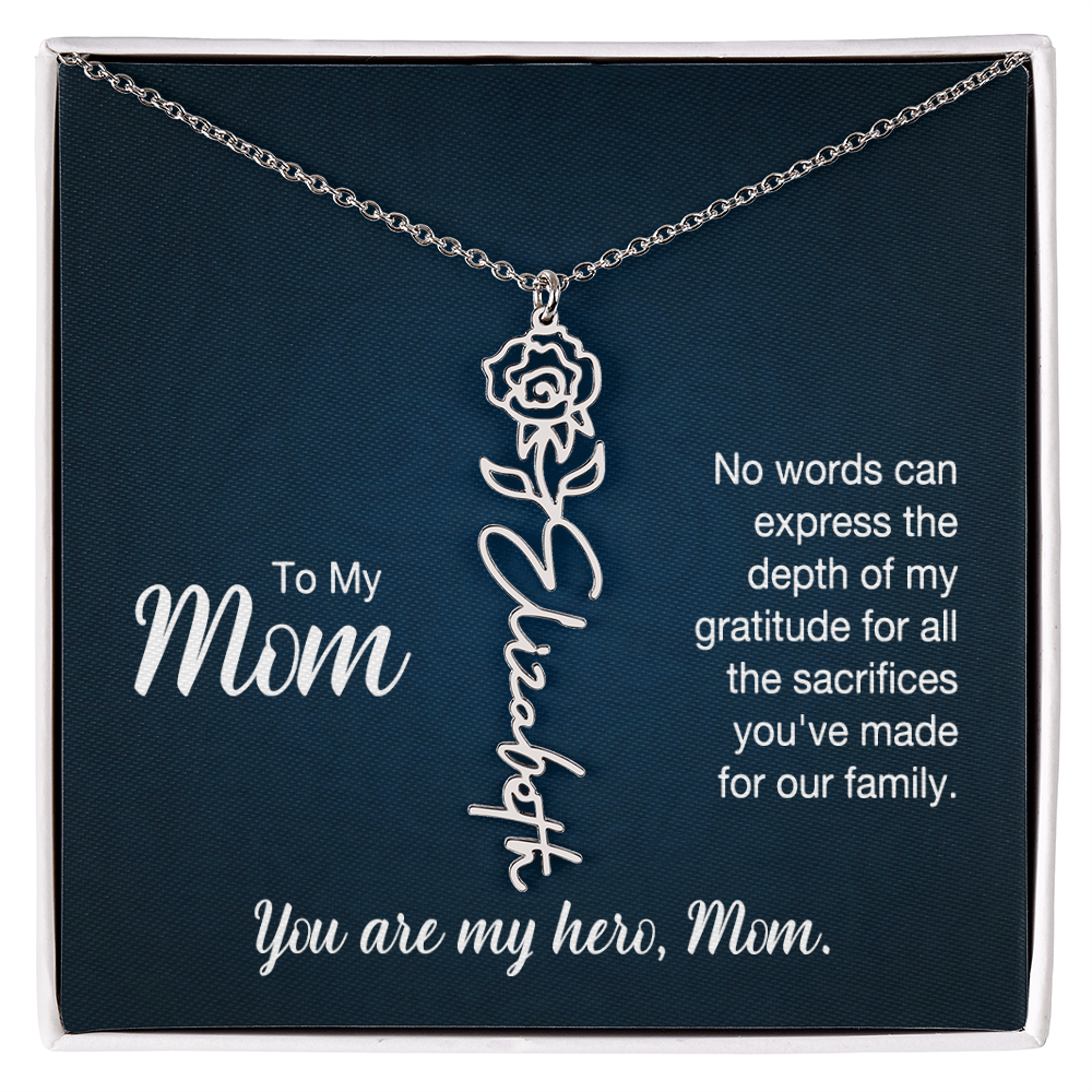 A silver floral filigree necklace with the name 'Elizabeth' engraved, presented on a dark blue gift card with sentimental text for 'Mom'.
