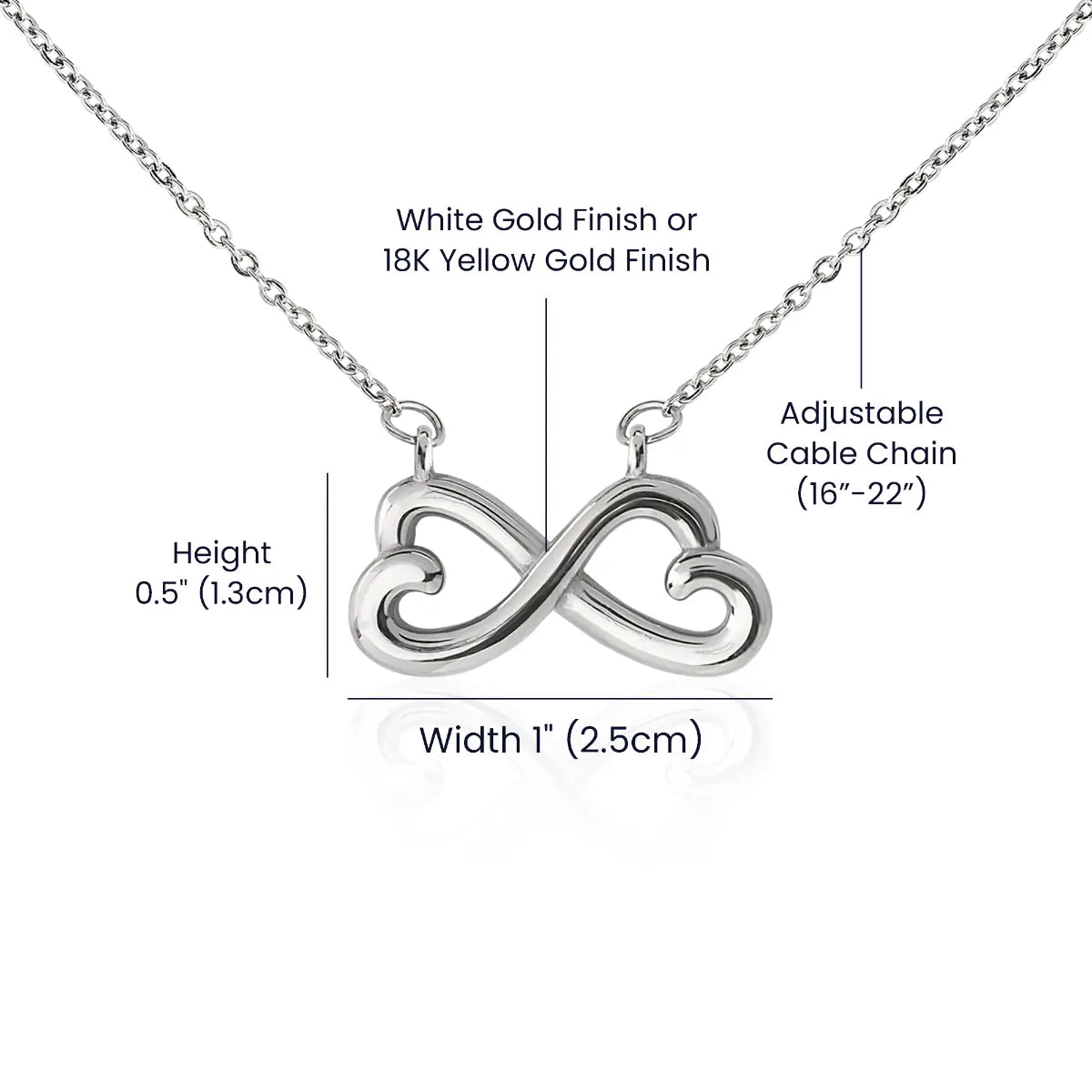Silver infinity necklace with adjustable cable chain on a white background