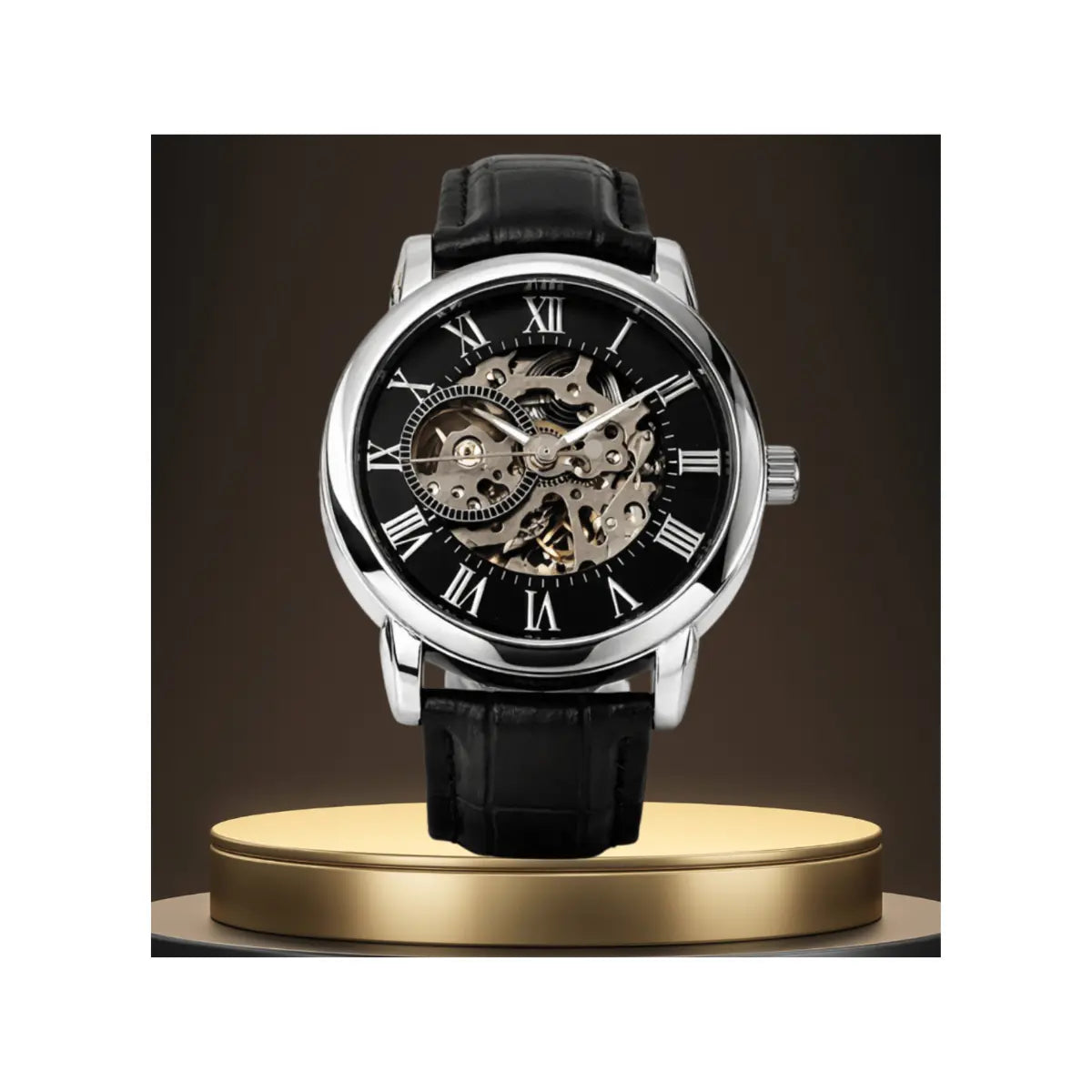 A front-facing close-up of a silver skeleton watch with a black face, Roman numerals, and a black leather strap resting on a gold circular platform against a dark brown background.