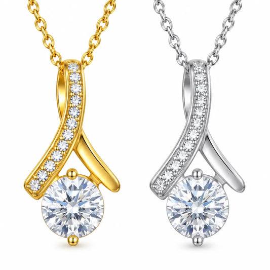 Two elegant pendant necklaces on a white background, one in yellow gold and one in silver, both featuring a round clear gemstone and a curved pavé-set chain detail.