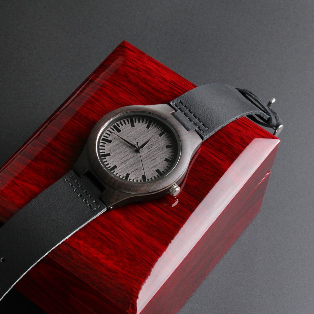 Wristwatch with gray strap on a red and gray background